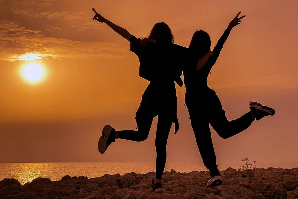 two teenage girls watching the sunset while preparing for university